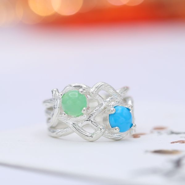 This two stone branch engagement ring pairs a cabochon cut chrysoprase with turquoise.