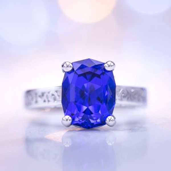 This tanzanite's blue would rival any sapphire. Precision cut in an elongated cushion shape, it's the star of this platinum engagement ring.