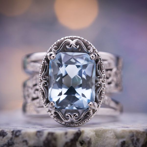 We designed this beautiful, bold aquamarine ring with tons of vintage detailing and a wide, multi-strand band. The centerpiece is a stunning, custom precision cut radiant aquamarine.