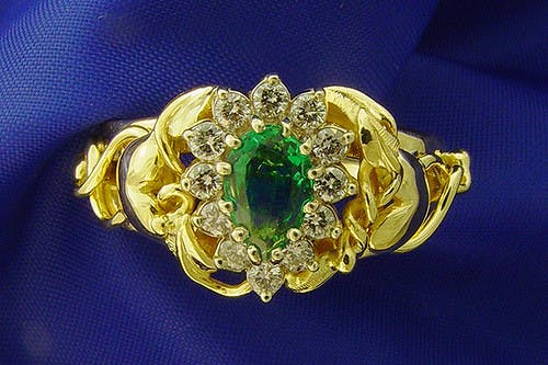 gold, emerald, and diamond ring