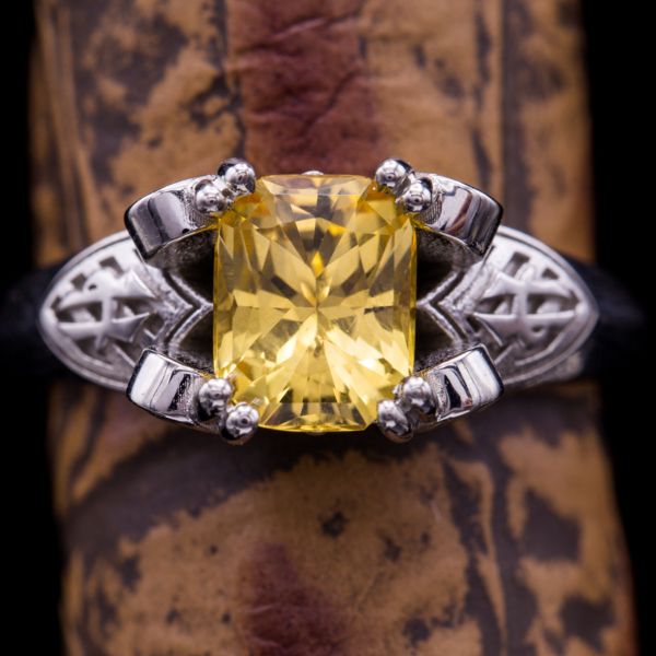 Imperial topaz ranges from yellow to peach-orange and pink, and is the most valued color range of topaz. Here, we found a radiant cut stone in a more purely yellow shade to match this Harry Potter fan's themed Hufflepuff engagement ring.