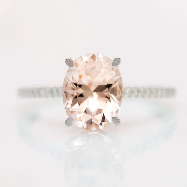 This salmon pink morganite lends its warmth to the crisp, modern white gold engagement ring.