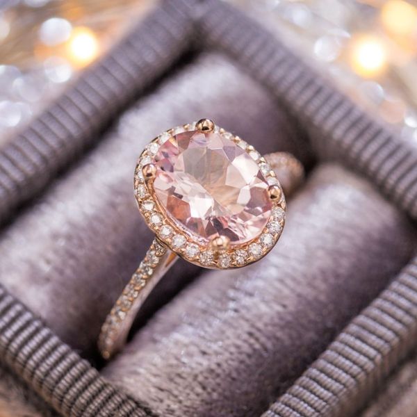 A contemporary classic in delicate rose gold with a diamond halo and pave surrounding the morganite center stone.
