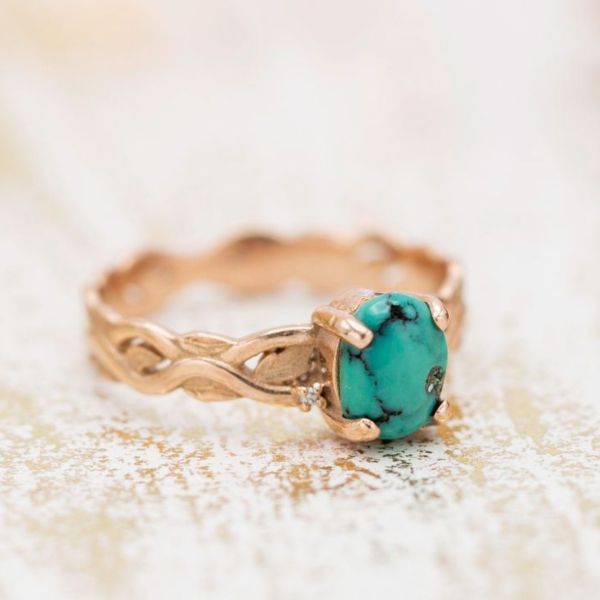 A bohemian engagement ring, with earthy rose gold and green-hued turquoise webbed with beautiful black veining.