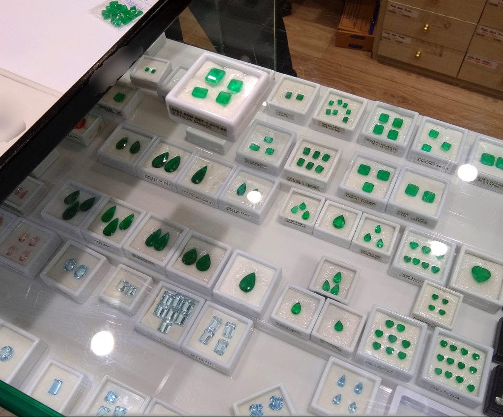 emeralds and aquamarines on display