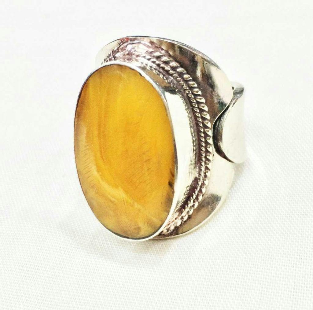 bezel-set amber ring - protective gem settings