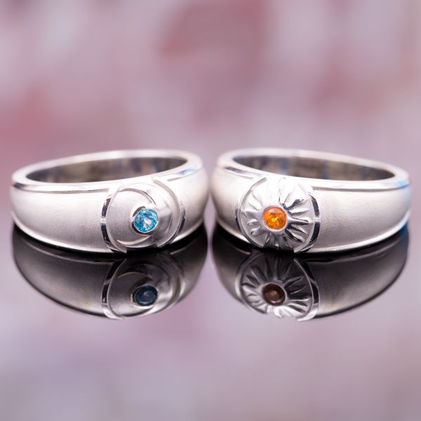 This pair of sun and moon wedding bands pairs two vivid, man-made shades of topaz: the vivid orange of passion poppy and the nearly neon green-blue of paraiba.