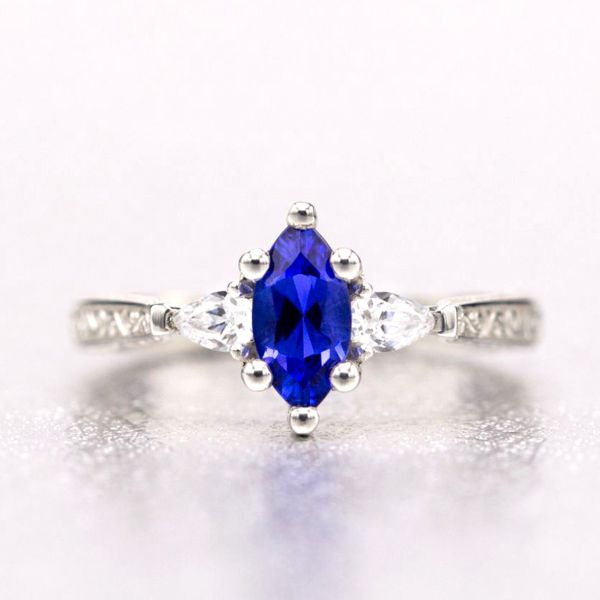 This engagement ring's marquise cut tanzanite has an intense, vivid blue color that pops against the diamonds and white gold of its setting.