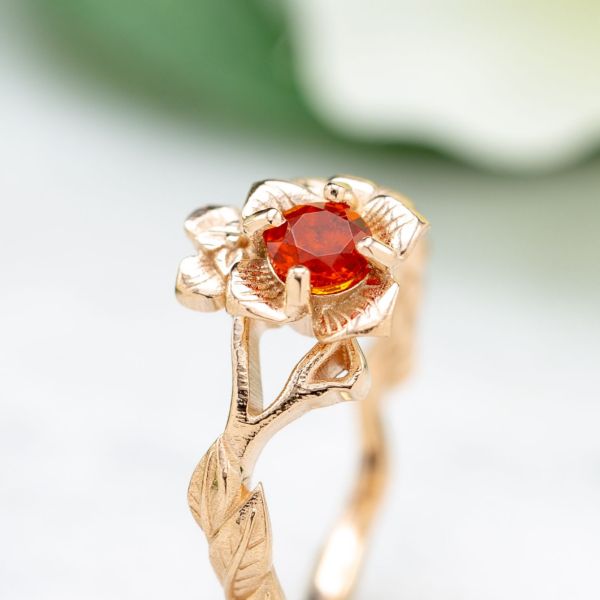 A cherry red fire opal adds a pop of bright color to this delicate, rose gold band inspired by the persimmon blossom.