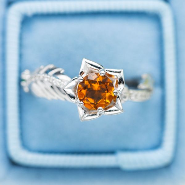 This flower engagement ring features a bright pop of yellow-orange citrine.