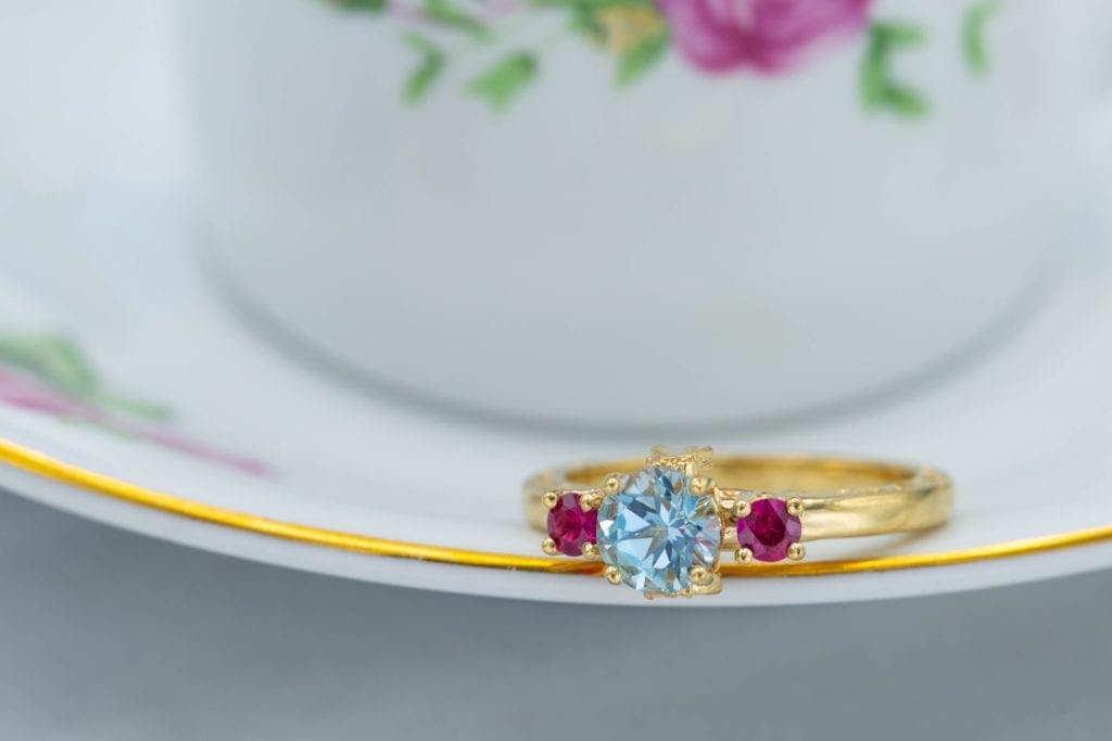 sky blue topaz engagement ring with ruby accents