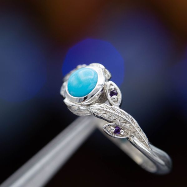 Feathers and amethysts pair perfectly with a clean blue turquoise in this engagement ring.