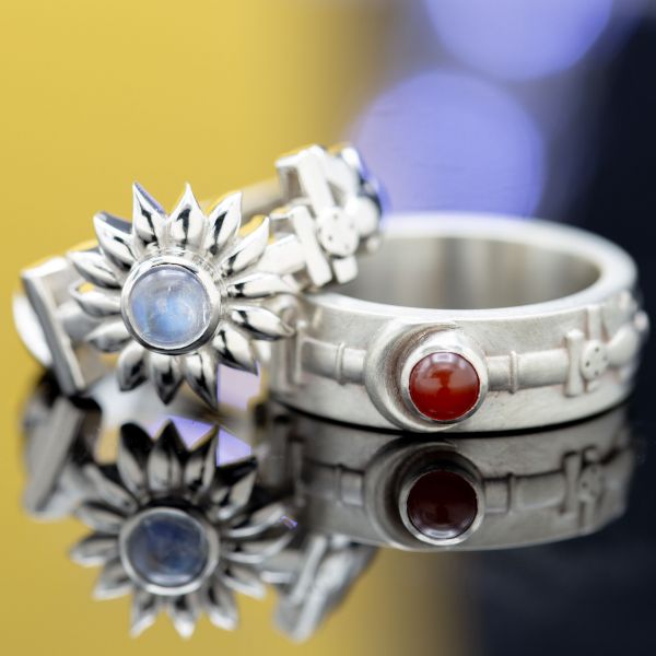 This unique ring set showcases a moonstone and a carnelian in unexpected roles in the rings' sun and moon theme. 