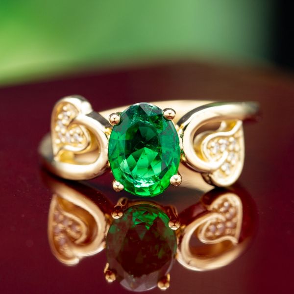 A clear, grass-green emerald is the perfect choice in this leafy, nature-inspired engagement ring.