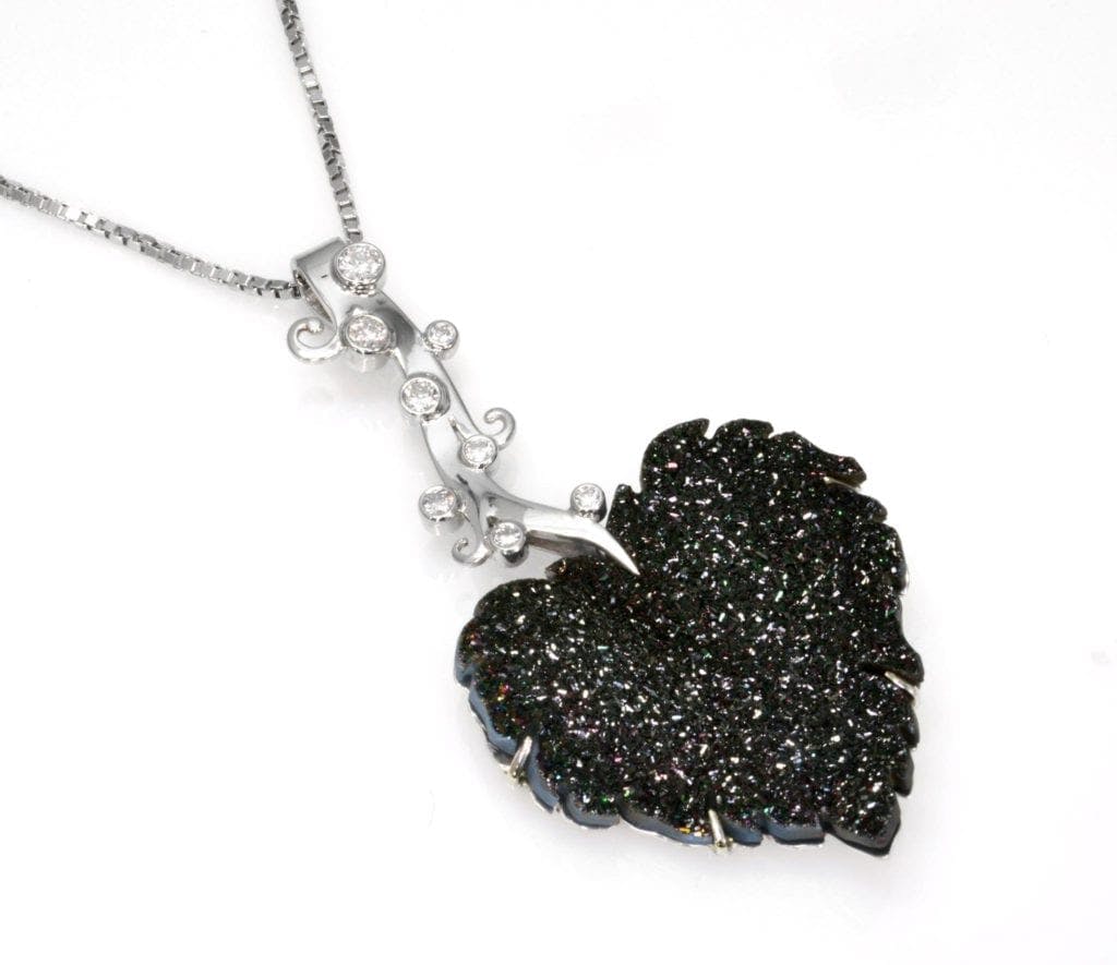 raw stone jewelry design and care - black druzy leaf