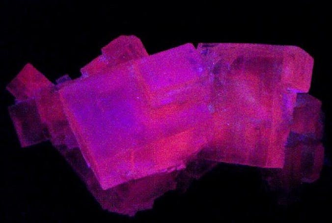 halites on matrix under UV light - Poland