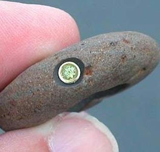 River rock with tube-set peridot