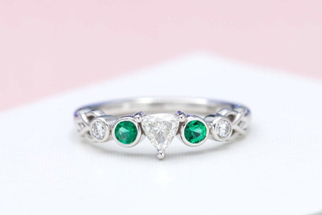 trillion-cut diamond and emerald engagement ring